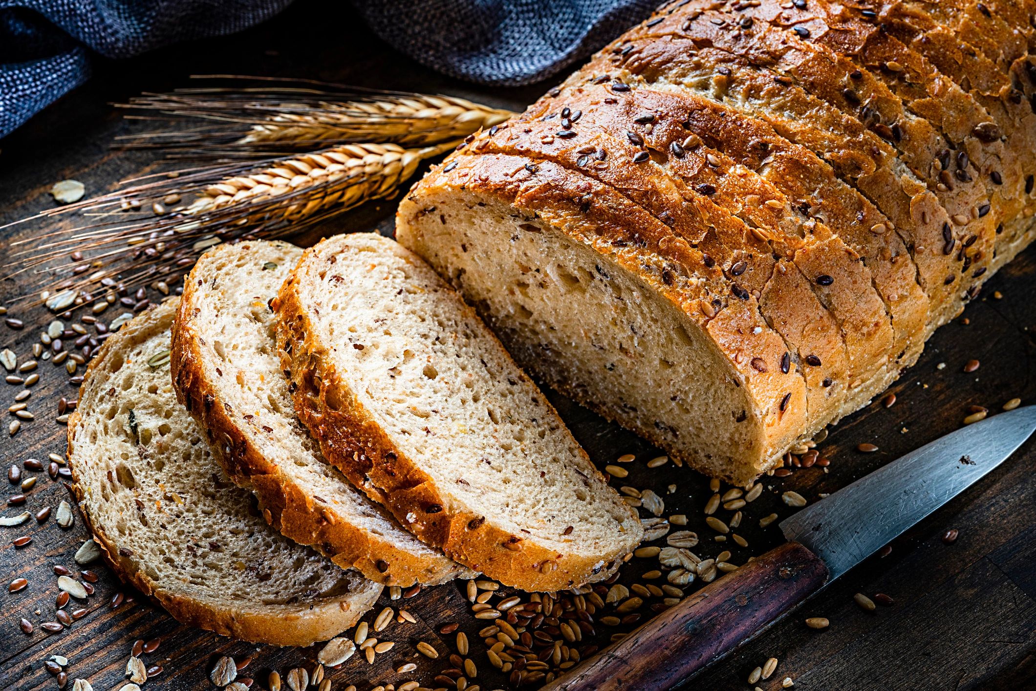 Sliced braided-style bread on a rustic wooden table (challah-style)