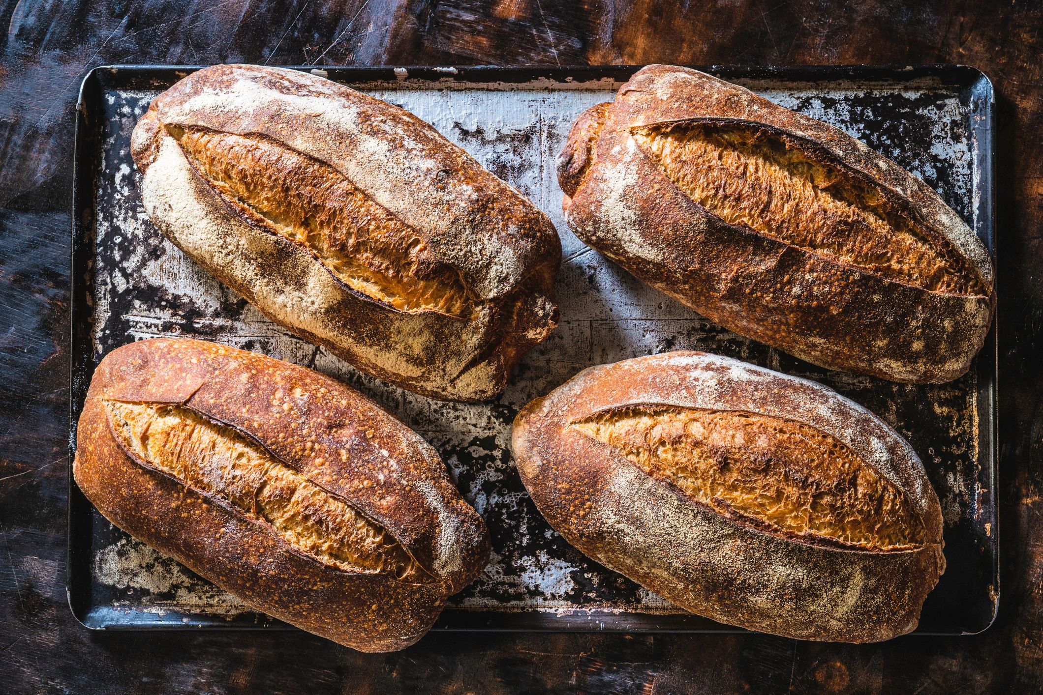 Fresh baked loaves in a tray, ready to cool