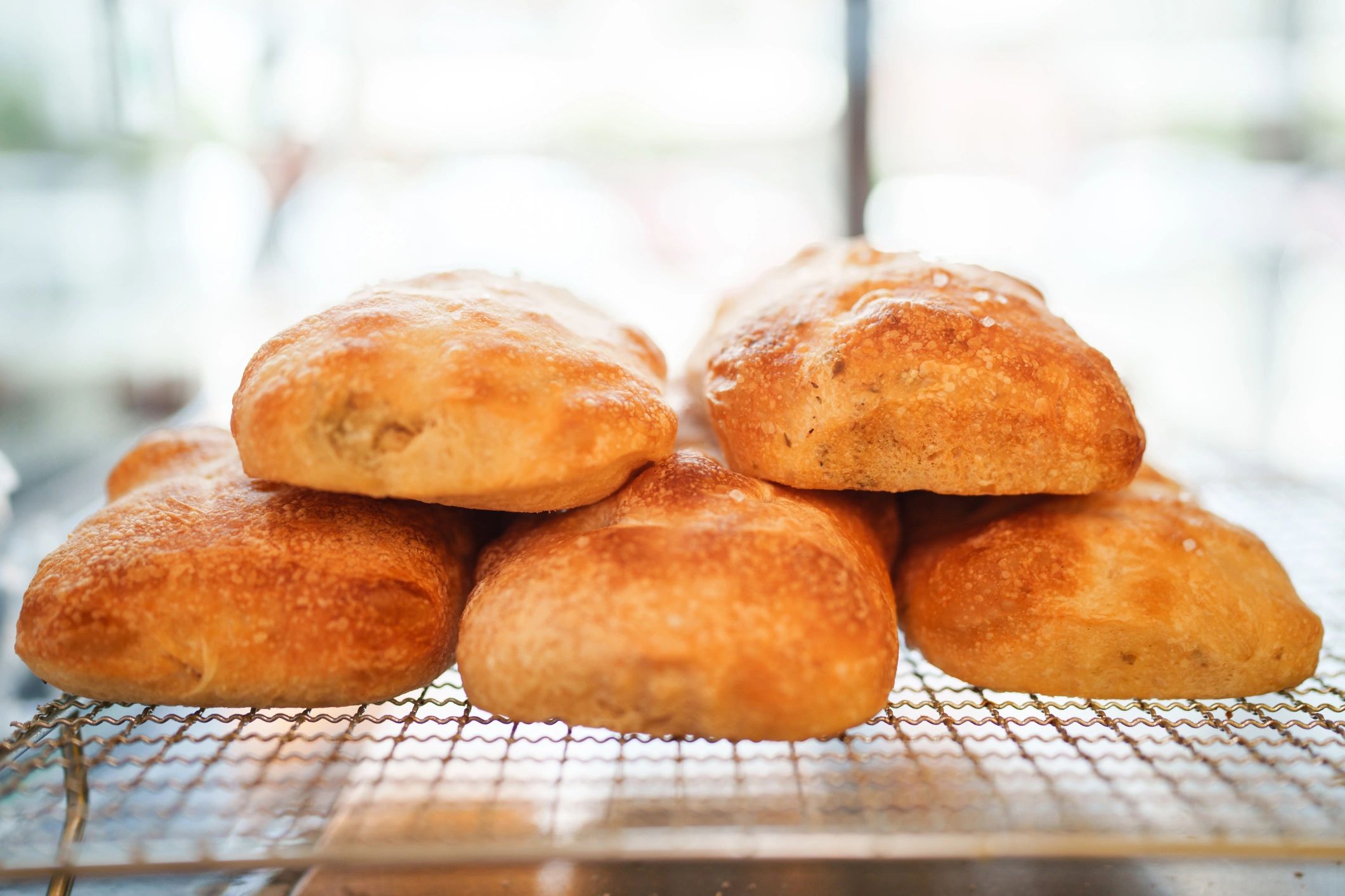 Fresh baked rolls cooling on a rack