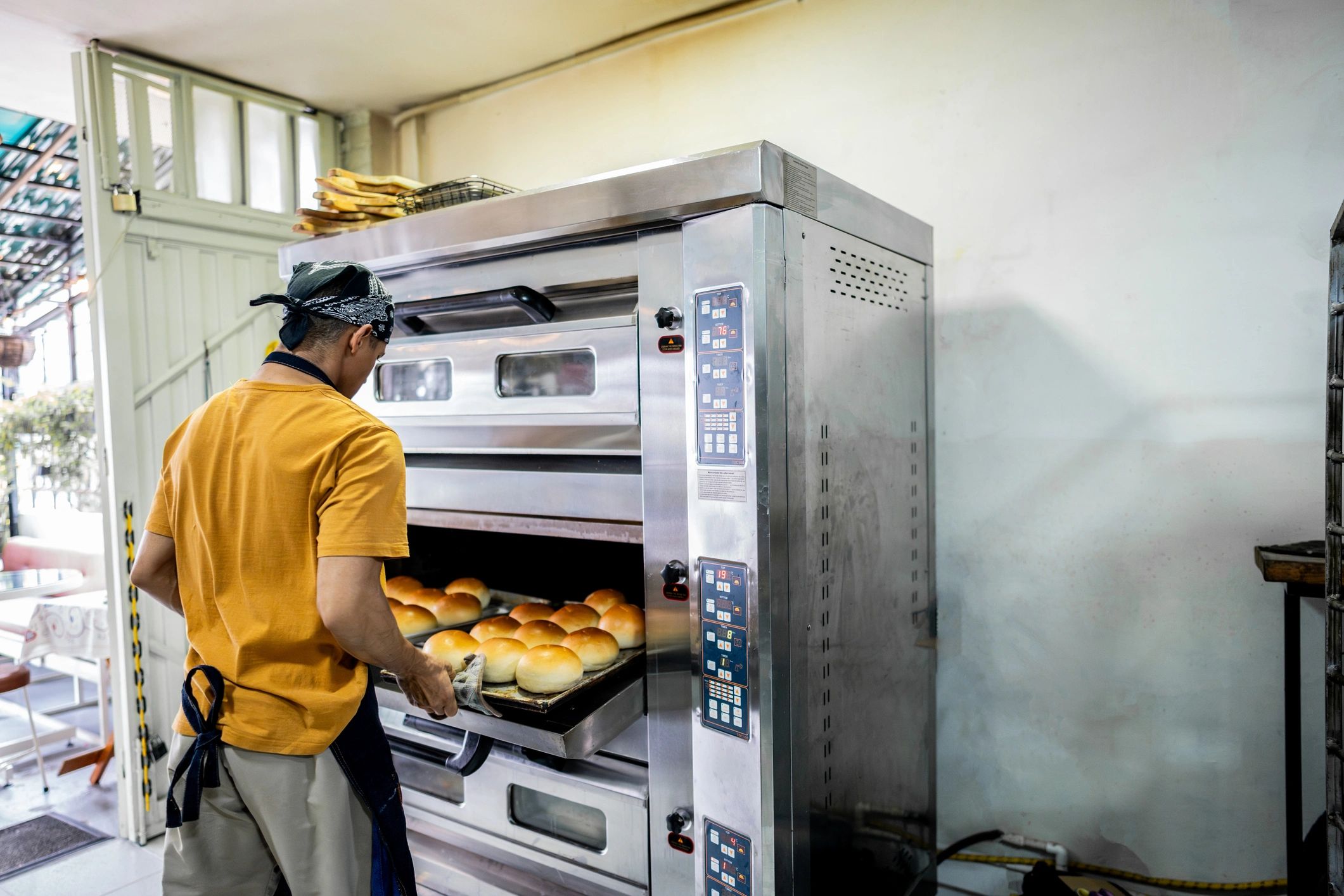 Hands working dough in a bakery kitchen