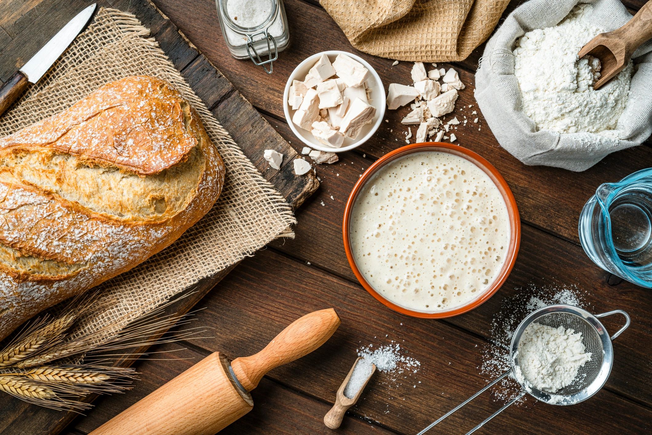 Bread-making ingredients and tools laid out for baking challah
